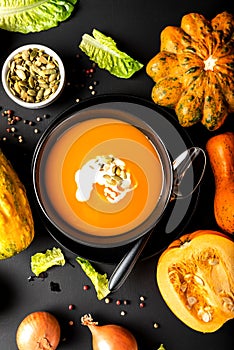 Pumpkin cream soup with milk. Top view. Autumn healthy vegetarian diet food