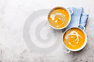 Pumpkin creamy soup decorated with fresh cream