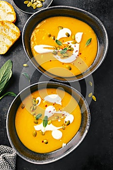 Pumpkin creamy soup served in bowls