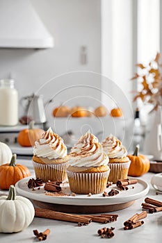 Pumpkin cupcakes with whipped cream cheese and dusted with cinnamon. Thanksgiving autumn dessert, generated AI