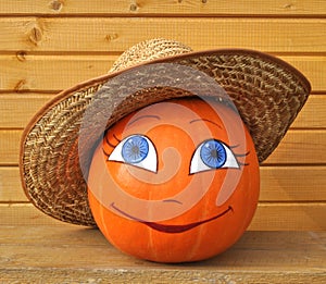 Pumpkin with female face in straw hat