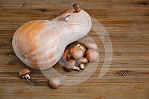 Pumpkin,Fresh Mushrooms on the Wooden Table.Autumn Garden's Vegetables