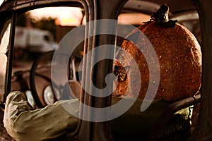 Pumpkin Head Man Sitting on a Old Rusty Truck