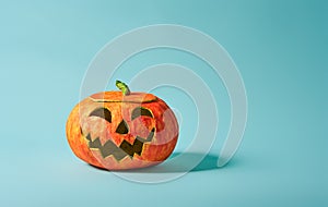 Pumpkin lantern on turquoise background