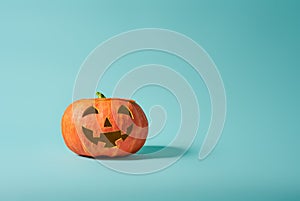 Pumpkin lantern on turquoise background