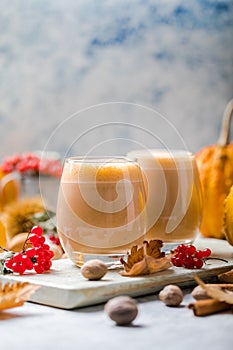 Pumpkin latte in a glasses. Autumn drink for Halloween or Thanksgiving