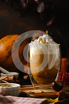 Pumpkin latte in a glasses. Autumn drink for Halloween or Thanksgiving.