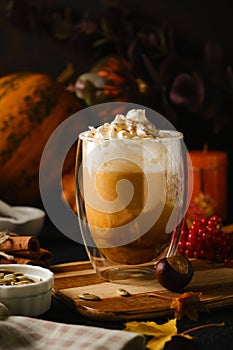 Pumpkin latte in a glasses. Autumn drink for Halloween or Thanksgiving.