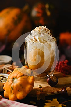 Pumpkin latte in a glasses. Autumn drink for Halloween or Thanksgiving.