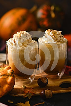 Pumpkin latte in a glasses. Autumn drink for Halloween or Thanksgiving.