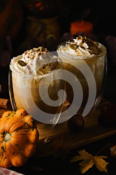 Pumpkin latte in a glasses. Autumn drink for Halloween or Thanksgiving.