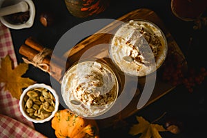 Pumpkin latte in a glasses. Autumn drink for Halloween or Thanksgiving.