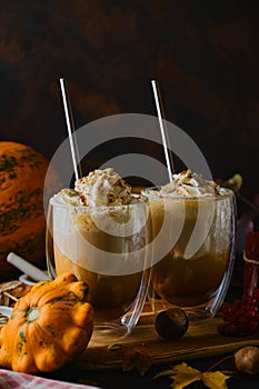 Pumpkin latte in a glasses. Autumn drink for Halloween or Thanksgiving.