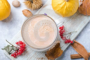 Pumpkin latte in mug. Autumn drink for Halloween or Thanksgiving