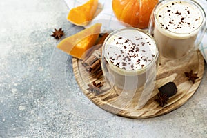 Pumpkin latte spice coffee on a stone background. Seasonal autumn concept with hot drink. Copy space