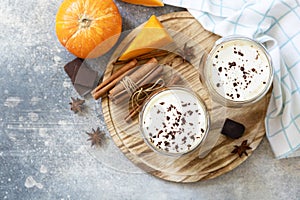 Pumpkin latte spice coffee on a stone background. Seasonal autumn concept with hot drink. View from above. Copy space