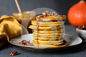 Pumpkin pancakes with caramel sauce and pecan nuts