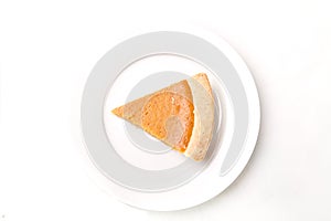 Pumpkin pie from above on white plate