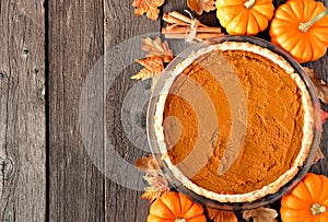 Pumpkin pie overhead table scene on rustic wood