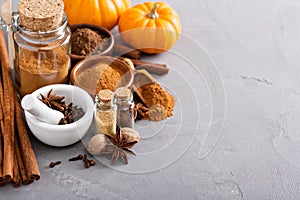 Pumpkin pie spice in a glass jar with ingredients