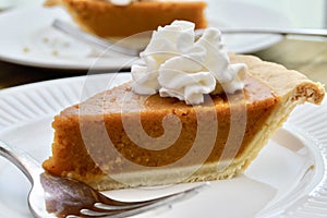 Pumpkin pie on a white plate