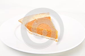 Pumpkin pie on white plate