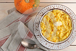 Pumpkin porridge with butter and a pumpkin