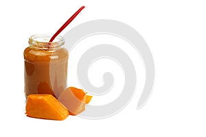 Pumpkin porridge in a glass jar isolated on white, natural, healthy baby food. Copy space