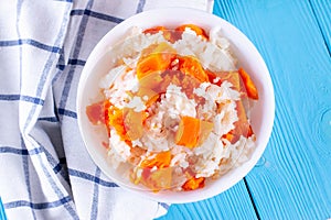 Pumpkin porridge with rice on a blue wooden background. Healthly food. Baby food