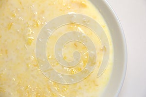 Pumpkin porridge with white rice in milk. On a white background