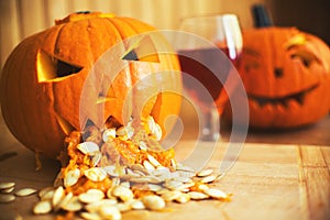 Pumpkin puking with pumpkin seeds on wood table, glass of wine, vintage effect