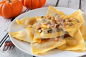 Pumpkin ravioli pasta, close up on a white plate