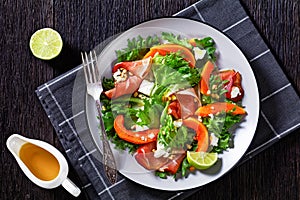 Pumpkin salad with lettuce, crumbled cheese, ham