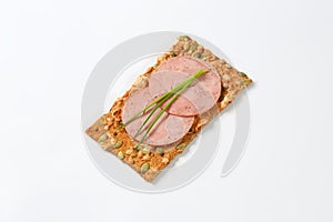 Pumpkin seed cracker with ham salami