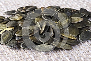 Pumpkin seeds against a background of light textiles