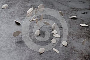 Pumpkin seeds are dropped and bounced on the cement floor