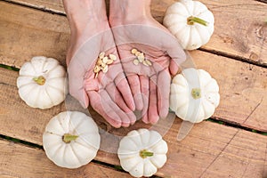 Pumpkin seeds lie in the palm of your hand