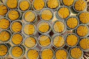 Pumpkin shaped chocolate fondant candy on a golden tray, soft focus close up