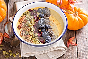 Pumpkin smoothie bowl with chia seeds, pecans, cranberries