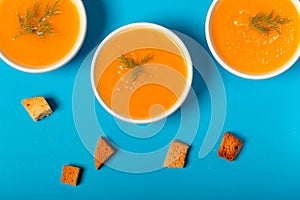 Pumpkin soup in a bowl with fresh dill herb