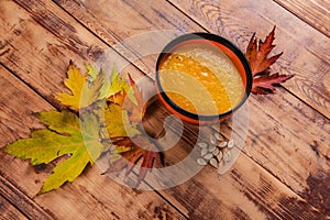 Pumpkin soup bowl on rustic wooden background