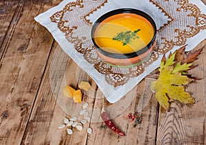 Pumpkin soup bowl on rustic wooden background