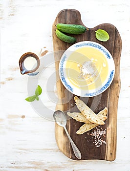 Pumpkin soup with cream, fresh basil, cucumbers