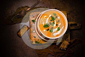 Pumpkin soup croutons parsley pumpkin seeds cream dark arrangement