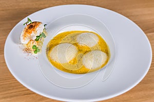 Pumpkin soup with espuma and herbs photo