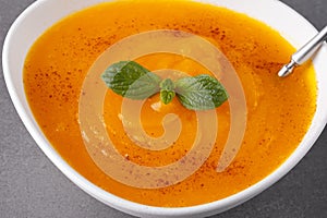Pumpkin soup on grey background