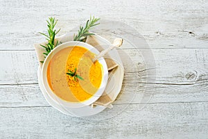 Pumpkin soup with linen napkin on light background.