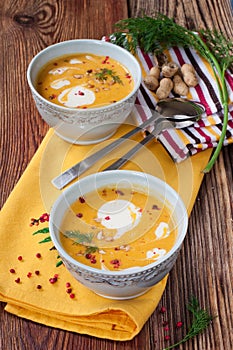 Pumpkin soup with peanuts on a wooden table