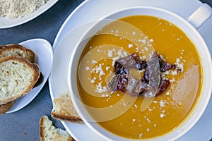 Pumpkin Soup with Proscuitto Parmesan Cheese and Crusty Bread Top View