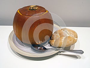 Pumpkin soup in a pumpkin bowl with Rustic Bread isolated image